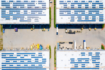 Modern European industry with low carbon footprint. Industrial warehouses in green fields. Technology park and factories  from above. - 509337459