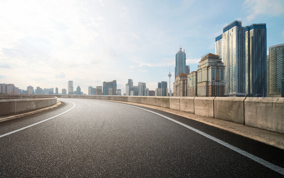 Low Angle Curvy Flyover Highway Moving Forward Road With Kuala Lumpur Cityscape Morning Scene View.