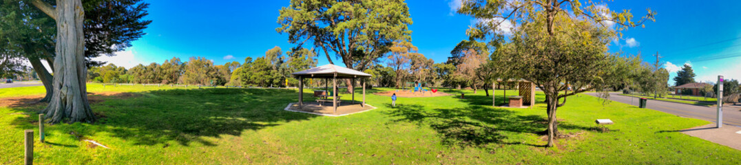 Panoramic view of a beautiful city park and playground on a sunny day
