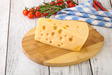 Maasdam cheese piece over board