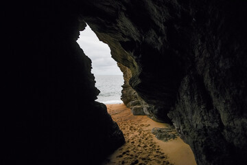 Cave by the ocean, exit from the cave from the inside.
