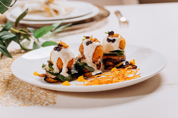 Fried cheese balls are served on a pillow of mushrooms and eggplant ready for eat. Restaurant menu