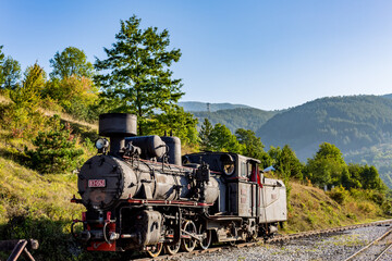 Old retro steam locomotive, Serbia. Sunny day European travel photograph.