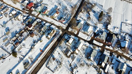 Fototapeta premium view from the height of the village with streets in winter. High quality photo