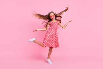 Fototapeta na wymiar Full body portrait of overjoyed carefree girl have fun hands throw hair isolated on pink color background
