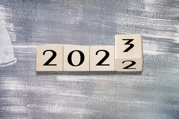 2023 on wooden block cube for new year change and start new business strategy concept.