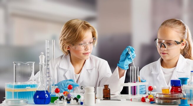 Science children education in chemistry lab. Kids or students with test tube making experiment at school laboratory