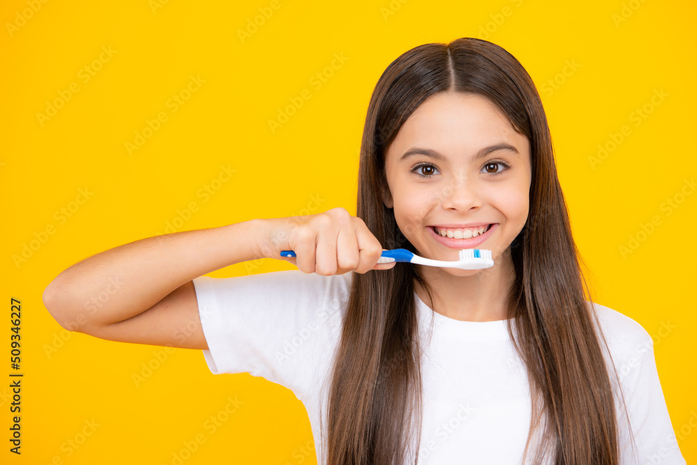 Canvas Prints happy teenager portrait. teenager girl brushing her teeth over isolated yellow background. daily hyg