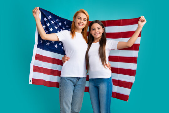 Patriotic Holiday. Happy Family, Mother And Daughter With American Flag On Blue Isolated Studio Background. USA Celebrate Independence Day 4th Of July.