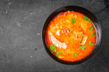 delicious hot traditional tom yam soup on a black background