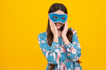 Teenager child girl in samba mask at carnival isolated on yellow background. Kids in carnival mask on birthday party, holidays concept.