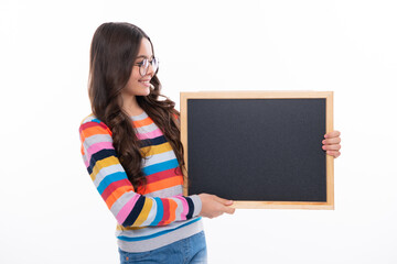 Teenage girl child hold chalkboard. Elementary school girl holding a blank blackboard chalk board. Copy space, mockup banner.