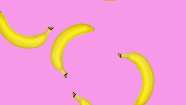 Abstract colorful animation - bananas falling and rotating at pink color background. Seamless loop animation.