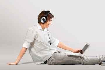 Happy Guy With Laptop Sitting On Floor  Cheerful Man Using PC Computer and Relaxing