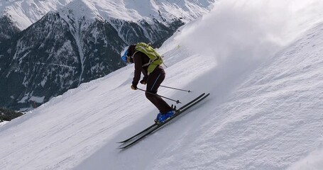 Amazing ski show of a young professional skier in a ski resort in the austrian alps. High speed skiing on a steep ski slope with fresh snow and amazing winter panorama. 4K pro follow camera skiing. - Powered by Adobe