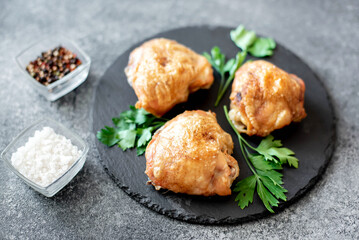 grilled chicken thighs on stone background