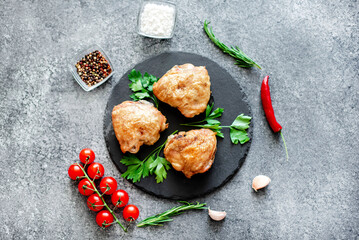 grilled chicken thighs on stone background