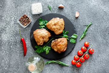 grilled chicken thighs on stone background