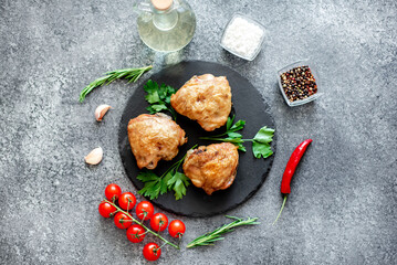 grilled chicken thighs on stone background