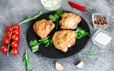 grilled chicken thighs on stone background
