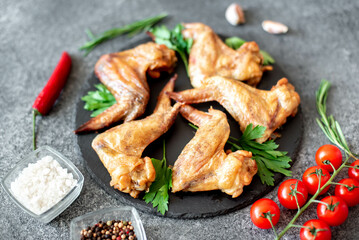 grilled chicken wings on stone background