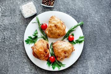 grilled chicken thighs on stone background