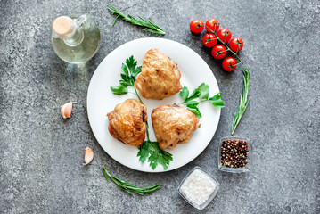 grilled chicken thighs on stone background