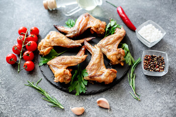 grilled chicken wings on stone background