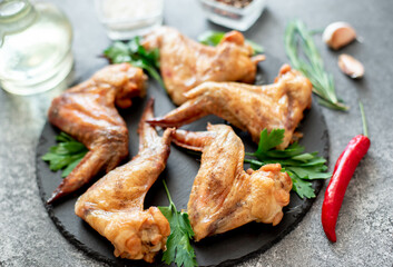 grilled chicken wings on stone background