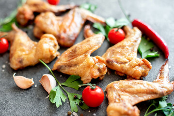 grilled chicken wings on stone background