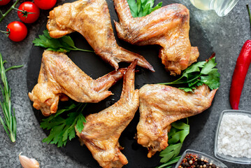 grilled chicken wings on stone background