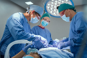 Team of surgeons performing operation at hospital