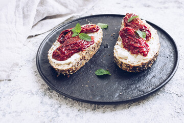 Bread slices with cream cheese and sun dried tomatoes