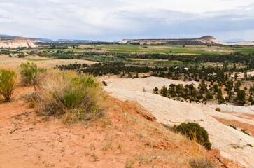 Sugarloaf dome, white slopes of Durffey Mesa and green fields of Boulder, Utah