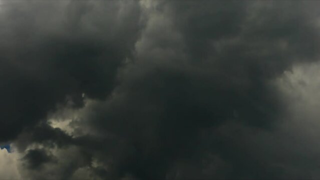 4K Time lapse, Gray and white rolling puffy clouds floating in the sky.