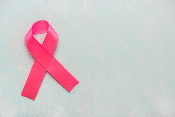 Top view of pink ribbon symbol breast cancer awareness with space for text