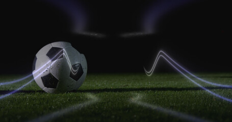 Image of neon shapes over football player kicking ball at stadium