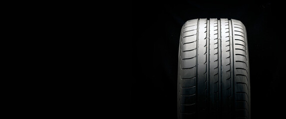 new summer tire on a black background, copyspace is a place for advertising