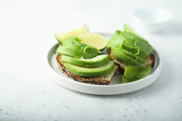 Homemade avocado toast with fresh lime