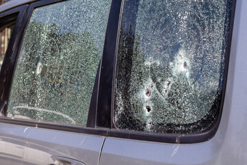 Traces of shots on the body of the car. War between Russia and Ukraine. Part of a civilian car that...