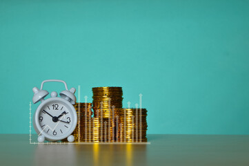 Clock and golden coins to collecting isolated on a green background. Saving money wealth and financial concept