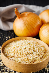 dried onions on a black wooden rustic background