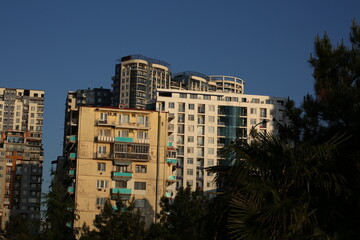Fototapeta na wymiar Facades of old tall buildings during sunset, southern buildings in a tropical climate