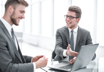 close up.colleagues discussing information sitting at the Desk