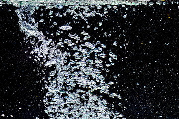Studio shot bubbles in water on black background. Abstract Background Concept