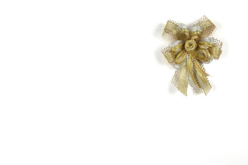 Golden bow is placed separately on a white background. The top view photo has copy space. as a postcard or greeting card