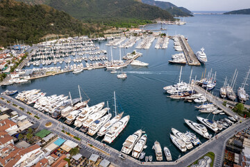Aerial views of boats anchored in seaside town marina (aerial drone photo). Marmaris, Turkey