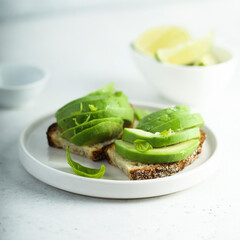 Homemade avocado toast with fresh lime