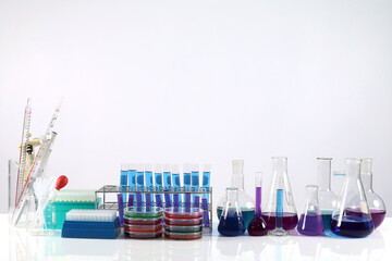 Microscope on the table with chemical tube and glassware in laboratory, Science research technology on the table and white background