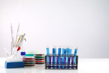 Concept of research and development of science laboratories microscope with test tube on the table and white background